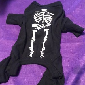 Worn once Adorable onesie with glow-in-dark skeleton on back